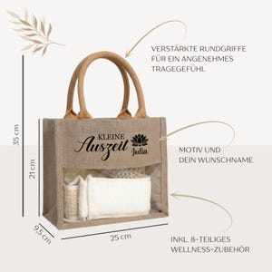 May include: A beige jute tote bag with a clear front panel, containing white and beige spa accessories. The bag has a brown handle and the text "Kleine Auszeit Julia" in black. Dimensions are 9.8 inches wide, 13.8 inches high, and 3.7 inches deep.