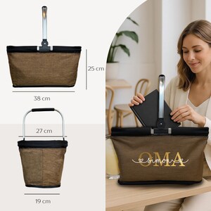 May include: Brown and black shopping basket with a silver handle. The basket is 38 cm long, 25 cm high, and 19 cm wide. The handle is 27 cm wide. The basket has the word "OMA" and the name "Simone" printed on it.