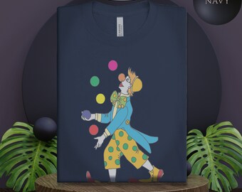 Könnte beinhalten: Ein marineblaues T-Shirt mit einem Motiv eines Clowns, der bunte Bälle jongliert. Der Clown trägt eine blaue Jacke, eine gelbe Hose mit grünen Punkten und einen gelben Hut. Der Text "CANVAS" ist auf dem Shirt sichtbar.