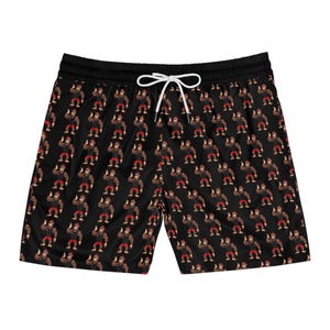 May include: Black swim shorts featuring a repeating pattern of a cartoon gorilla giving a thumbs-up. The shorts have a black drawstring waistband. The gorilla is brown with red shorts and a black shirt.