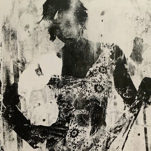May include: Monochrome artwork of a person in a floral patterned dress. The image is a high-contrast print, with the figure's form and dress details defined by dark areas against a lighter background. The dress features a repeating floral design.