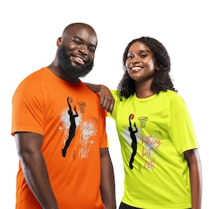 May include: Two people wearing bright orange and yellow t-shirts with basketball graphics. The orange shirt has a basketball player silhouette with the text "Nothing but Net". The yellow shirt has a basketball player silhouette with the text "Nothing but Net".