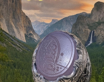May include: A silver ring with a large, oval, lavender-colored stone. The stone has an engraved design. The ring is set against a backdrop of a mountain range and a waterfall. Gold Arabic script is at the top.