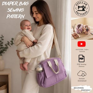 May include: A digital sewing pattern for a nappy bag, featuring a purple bag with cream-coloured straps and a side pocket holding a baby bottle. The image includes text labels for a YouTube video tutorial, a PDF sewing pattern, and instant download.