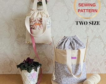 May include: Two drawstring tote bags with cream-colored canvas and patterned fabric accents. One bag is hanging, and the other is upright, with knitting needles and a ball of yarn. The text "PDF SEWING PATTERN TWO SIZE" is in a gold circle.