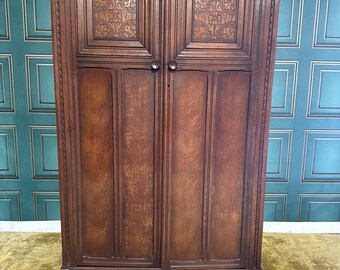 Vintage dark oak double doored wardrobe, having an internal full shelf and hanging rail.