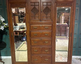 Victorian mahogany compactum wardrobe having two upper central carved cupboard doors with internal shelf, over five graduates drawers