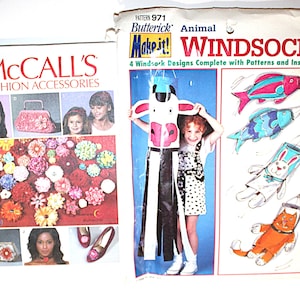 May include: Two vintage sewing pattern packets. One is McCall's Fashion Accessories, featuring images of purses, flowers, and shoes. The other is Butterick's Animal Windsocks, with designs for a cow, fish, rabbit, and cat. The Butterick pattern is marked $4.95.