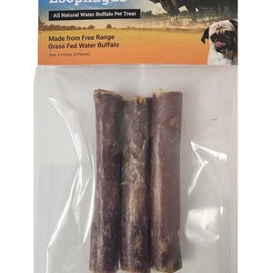 May include: A clear plastic package containing three dark brown, cylindrical dog treats. The packaging includes text that reads "Pizzle Stuffed Esophagus" and "All Natural Water Buffalo Pet Treat". The treats are 6 inches long.