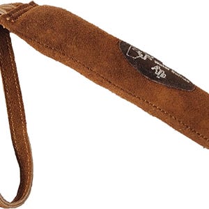 May include: Brown leather dog training tool with a suede handle and a loop for attaching to a leash. The tool has a brown leather patch with the text "Alp" on it.
