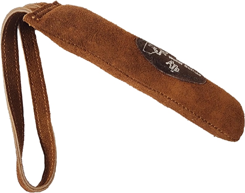 May include: Brown leather dog training tool with a suede handle and a loop for attaching to a leash. The tool has a brown leather patch with the text "Alp" on it.