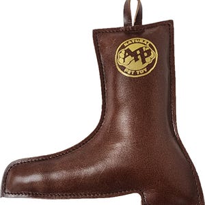 May include: Brown leather dog toy shaped like a boot with a gold logo that says "Natural Pet Toy".