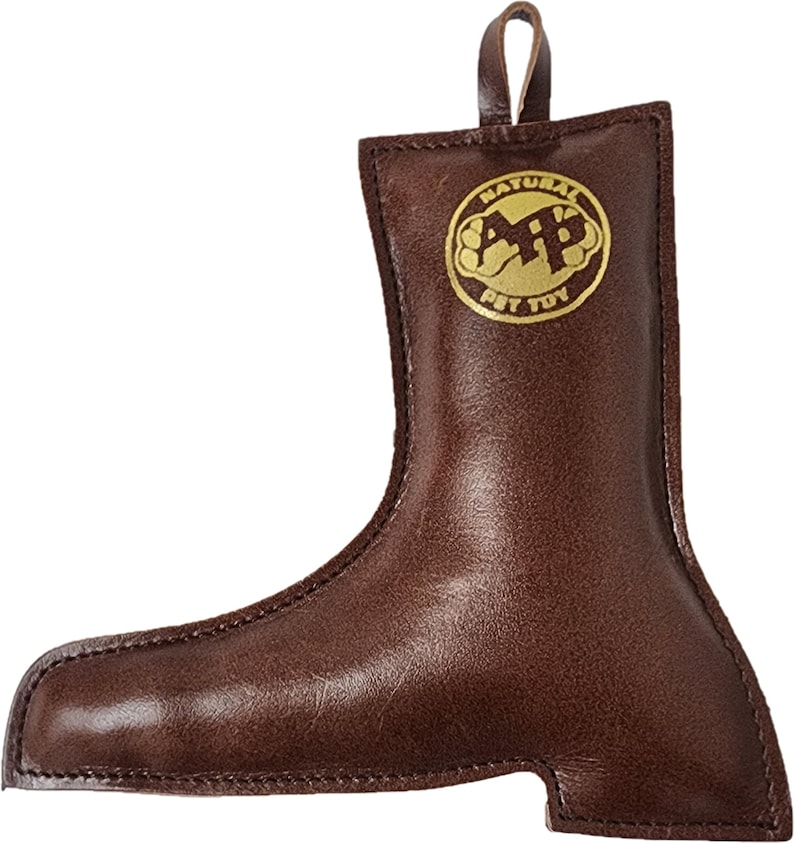 May include: Brown leather dog toy shaped like a boot with a gold logo that says "Natural Pet Toy".