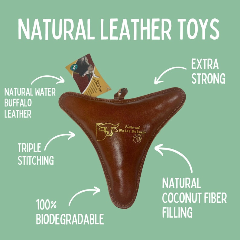 May include: A brown leather dog toy shaped like a triangle with a gold logo that says "Natural Water Buffalo". The toy is filled with natural coconut fiber and has triple stitching for extra strength. It is 100% biodegradable.