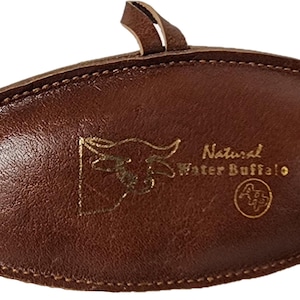 May include: A brown leather oval-shaped pouch with a gold embossed image of a buffalo head and the text "Natural Water Buffalo".