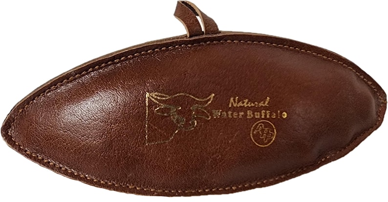 May include: A brown leather oval-shaped pouch with a gold embossed image of a buffalo head and the text "Natural Water Buffalo".