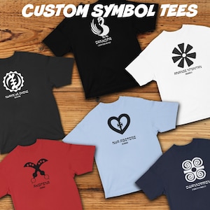 May include: Six different t-shirts with various African symbols and their corresponding names printed on them. The shirts are laid out on a wooden surface with a pair of flip-flops, sunglasses, and a straw hat.