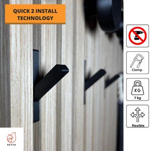 May include: Black metal hooks mounted on a wooden wall. The hooks are designed for easy installation and can hold up to 7 kg. The text "Quick 2 Install Technology" is visible in the top left corner of the image.