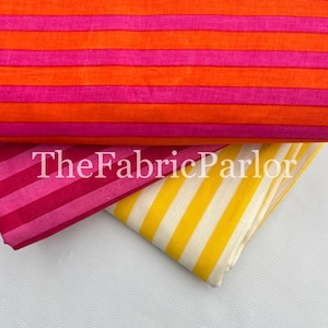 Puede incluir: Tres piezas de tela dobladas con rayas horizontales y diagonales. La tela superior tiene rayas naranjas y rosas, la del medio tiene rayas rosas y magenta, y la inferior tiene rayas amarillas y blancas. El texto dice TheFabricParlor.