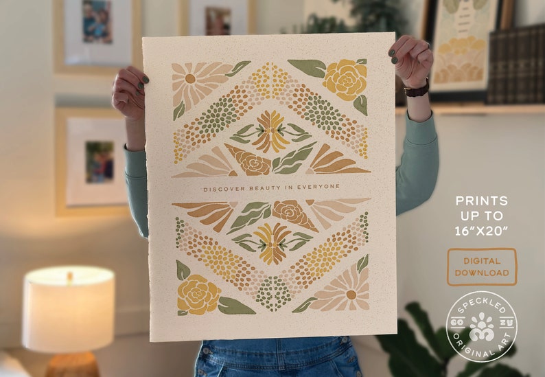 May include: A digital art print featuring a geometric pattern of flowers in shades of yellow, green, and pink. The print has the text "DISCOVER BEAUTY IN EVERYONE" at the bottom and is available in sizes up to 16 inches by 20 inches.
