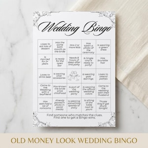 May include: A black and white Wedding Bingo game card with a decorative floral border. The card features a grid of phrases related to weddings, such as "Is wearing a green dress" and "Loves to drink beer." The text "OLD MONEY LOOK WEDDING BINGO" is at the bottom.