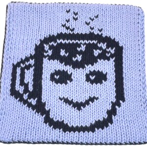May include: A light blue knitted square with a black coffee cup design. The cup has a smiling face and steam rising from the top. The edges are black.