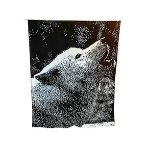 May include: Black and white tapestry featuring a stylized wolf howling at the moon. The wolf is made up of small white dots on a black background.