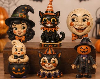 May include: A collection of six Halloween-themed figurines including a witch, a black cat in a striped hat, a moon face, a ghost in a pumpkin cauldron, a cat with a ruffled collar, and a pumpkin-headed figure in a suit and hat.