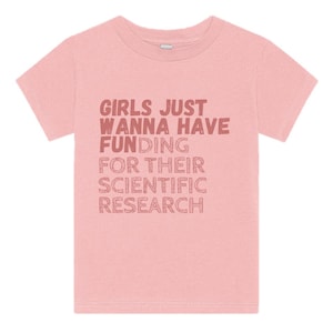 May include: Pink short-sleeved t-shirt with the text "Girls Just Wanna Have Funding For Their Scientific Research" in a red-brown color.