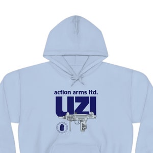 May include: A light blue hooded sweatshirt with a navy blue graphic of a Uzi submachine gun and the text "action arms ltd. UZI".