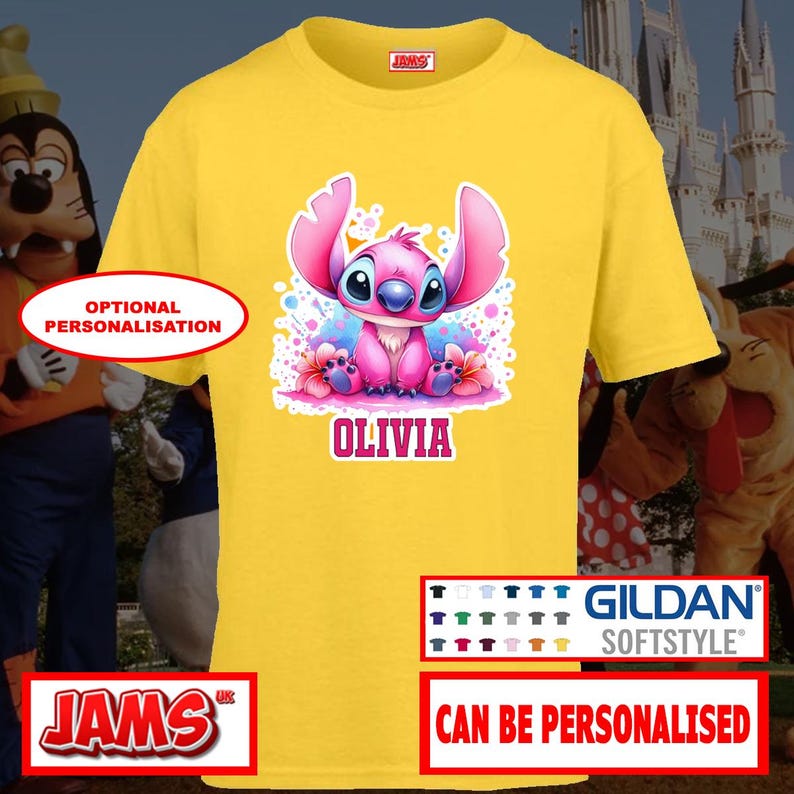 May include: A yellow Gildan Softstyle t-shirt featuring a pink cartoon character with the name "OLIVIA" in pink text. The shirt has a crew neck and short sleeves. The design includes the text "CAN BE PERSONALISED".