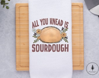 May include: White kitchen towel with a brown sourdough bread design and the text "All you knead is sourdough".