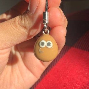 Pou Keychain meme