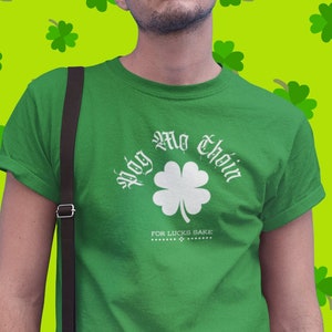May include: A green t-shirt with a white shamrock and the text "Sláinte Mhath" in a white gothic font. The text below the shamrock reads "For the Lucky Ones".