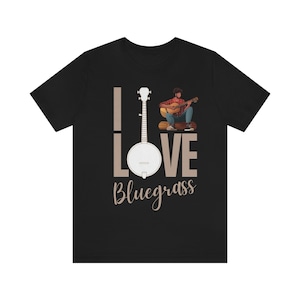 May include: Black t-shirt featuring a white banjo and the text "I Love Bluegrass". A cartoon person is playing a guitar.