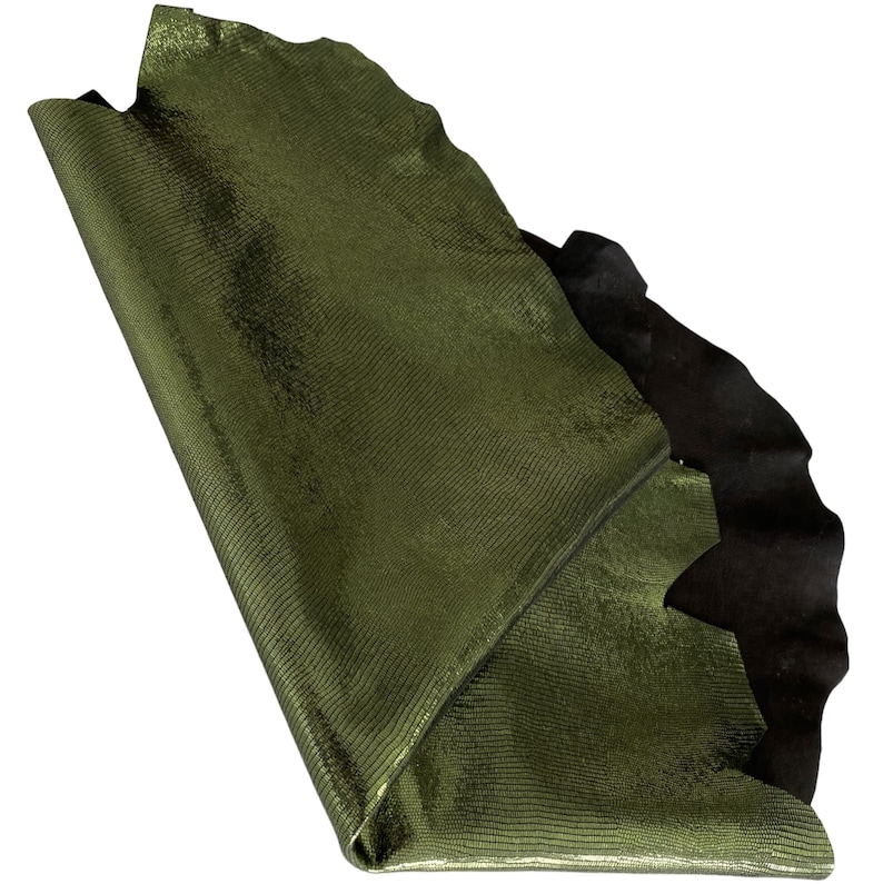 May include: A piece of green snakeskin leather with a textured surface. The leather is folded in half and the edges are visible.