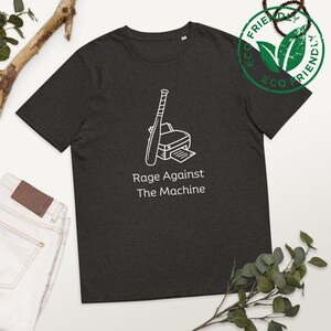 May include: A dark grey t-shirt with a white outline of a printer with a baseball bat on top of it. The text "Rage Against The Machine" is printed below the image.