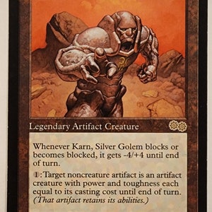 May include: A Magic: The Gathering card featuring a silver golem creature named Karn, Silver Golem. The card has a power of 4 and a toughness of 4. The card text reads: "Whenever Karn, Silver Golem blocks or becomes blocked, it gets -4/+4 until end of turn. 1: Target noncreature artifact is an artifact creature with power and toughness each equal to its casting cost until end of turn. (That artifact retains its abilities.)"
