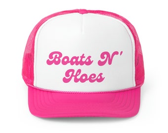May include: A pink and white trucker hat with the text "Boats N' Hoes" in pink cursive lettering.