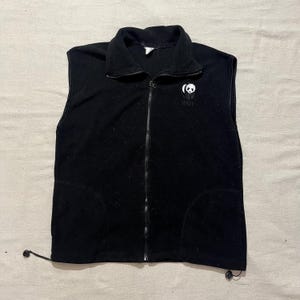 May include: Black fleece vest with a zipper closure and a panda logo that says "WWF" on the front.