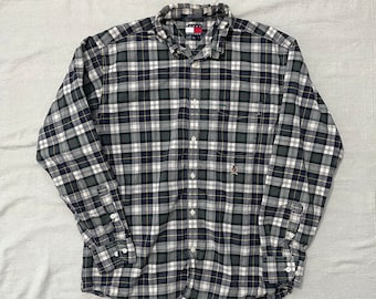 May include: A long-sleeved plaid button-down shirt in black, green, and white with a small Tommy Hilfiger logo on the pocket.