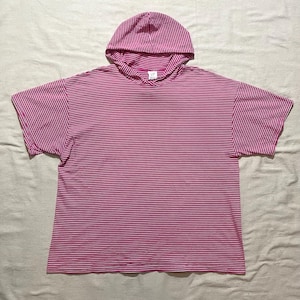 May include: A pink and white striped hooded t-shirt with short sleeves.