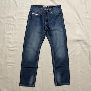 May include: A pair of blue denim jeans with a faded wash and a straight leg fit. The jeans have a button fly and belt loops. The brand name "GRND" is visible on the back pocket.