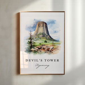 May include: Watercolor painting of Devil's Tower National Monument in Wyoming. The painting depicts the iconic rock formation with a green grassy foreground and a blue sky with clouds.