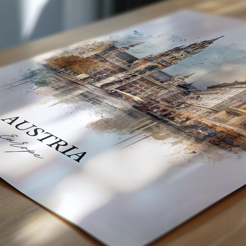 May include: A watercolour print featuring a European city, with the word "AUSTRIA" in bold black letters. The word "Europe" is written in cursive below. The artwork depicts a detailed building with multiple spires and architectural details.