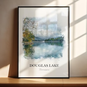 May include: A framed watercolor print of Douglas Lake in Tennessee. The artwork depicts a serene lake scene with trees and mountains in the background. The print has a black frame and the text "DOUGLAS LAKE Tennessee".
