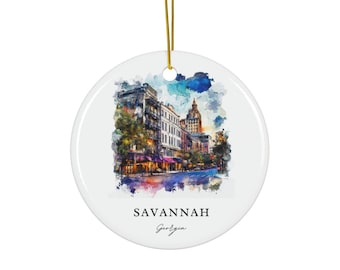 May include: A round white ceramic ornament featuring a watercolor-style illustration of a Savannah, Georgia street scene with historic buildings and trees. The text SAVANNAH and Georgia is printed in black below the image. A gold string is attached.