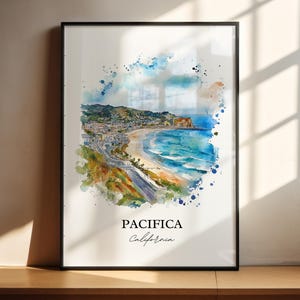 May include: A framed watercolor print of Pacifica, California. The artwork depicts a coastal landscape with a beach, ocean, and town, surrounded by colorful watercolor splashes. The word "Pacifica" and "California" are written in the bottom center.
