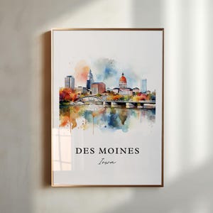 May include: Watercolour painting of the Des Moines skyline, featuring the Iowa State Capitol building and a bridge over a river. The painting is in a gold frame and has a white background.