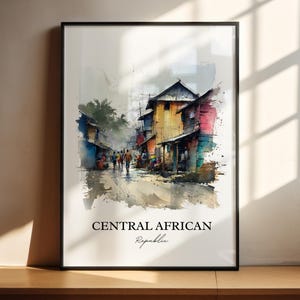 May include: Watercolor print of a street scene in the Central African Republic, framed in black. The artwork depicts colorful buildings and people walking on a wet street. The text "CENTRAL AFRICAN Republic" is at the bottom.